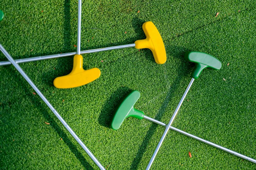 Mini Golf putters on green
